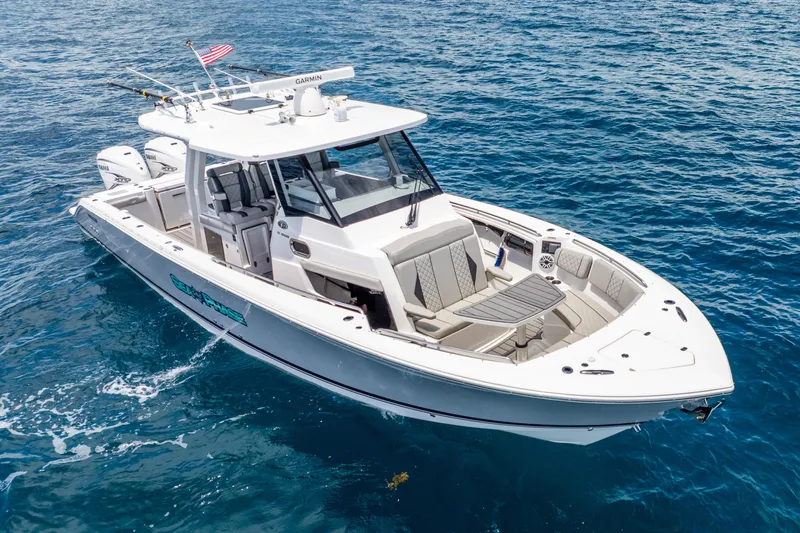 Sea Phase Yacht Photos Pics 2024 Pursuit S 358 Sport boat cruising on clear blue ocean waters.