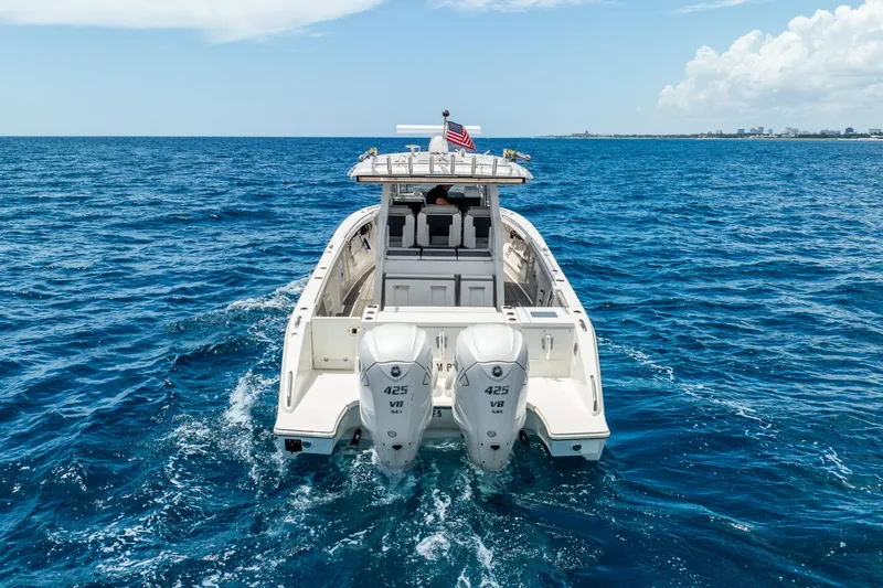 Sea Phase Yacht Photos Pics 2024 Pursuit S 358 Sport boat cruising on open ocean with twin engines.