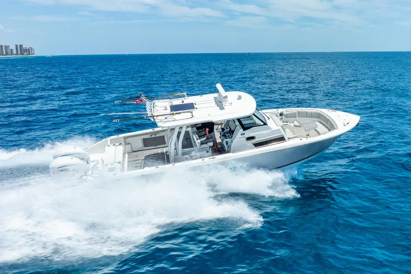 Sea Phase Yacht Photos Pics 2024 Pursuit S 358 Sport boat cruising on open blue ocean.