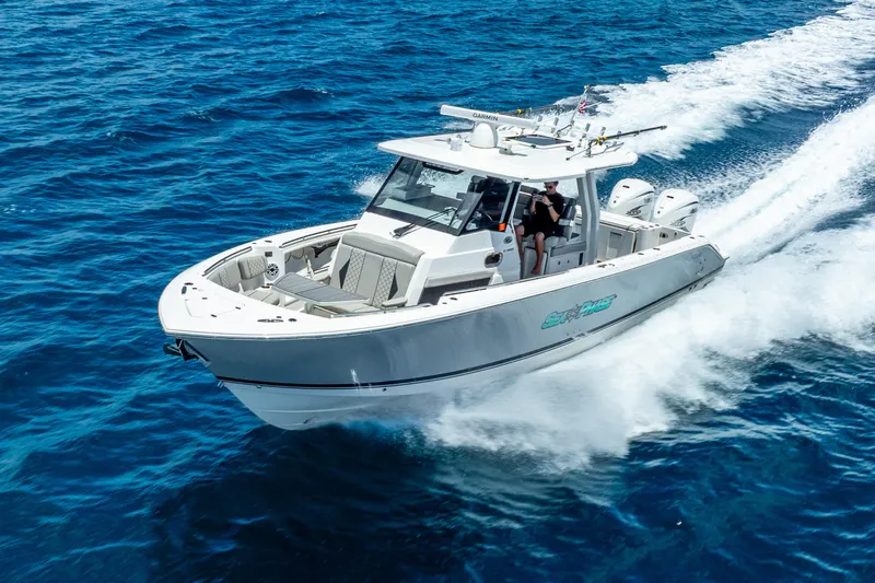 Sea Phase Yacht Photos Pics 2024 Pursuit S 358 Sport boat cruising on open blue water.