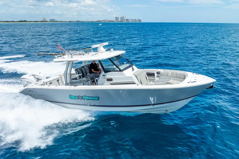 Sea Phase Yacht Photos Pics 2024 Pursuit S 358 Sport boat cruising on open blue ocean.