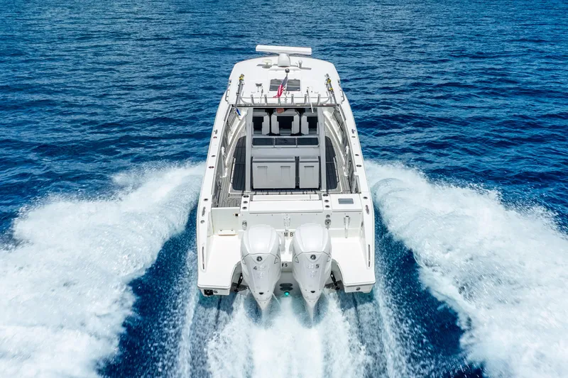 Sea Phase Yacht Photos Pics 2024 Pursuit S 358 Sport boat cruising on open blue water.