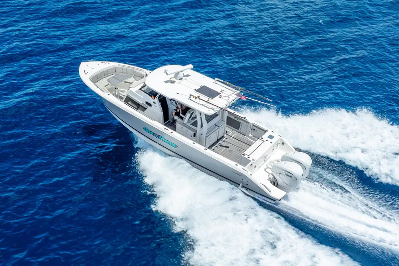 Sea Phase Yacht Photos Pics 2024 Pursuit S 358 Sport boat cruising on open blue ocean waters.