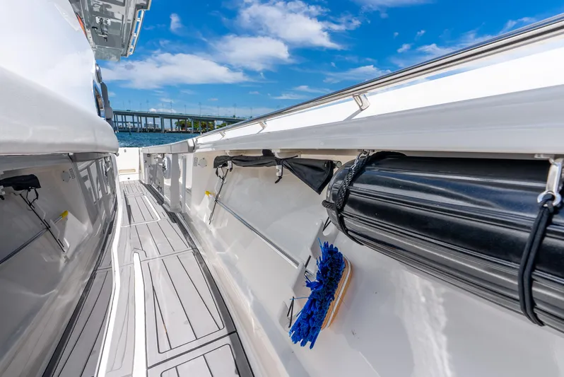 Sea Phase Yacht Photos Pics 2024 Pursuit S 358 Sport boat deck with storage compartments and clear blue sky.