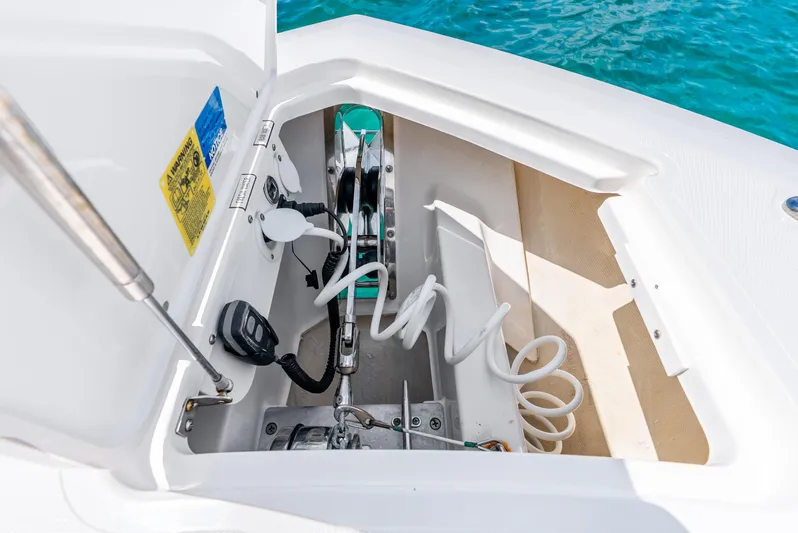 Sea Phase Yacht Photos Pics 2024 Pursuit S 358 Sport boat anchor compartment with coiled rope and control panel.