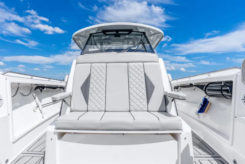 Sea Phase Yacht Photos Pics 2024 Pursuit S 358 Sport boat interior with luxurious seating under a clear blue sky.