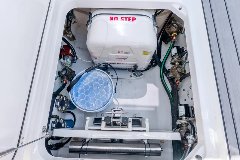 Sea Phase Yacht Photos Pics 2024 Pursuit S 358 Sport boat engine compartment with generator and mechanical components.