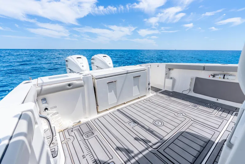 Sea Phase Yacht Photos Pics 2024 Pursuit S 358 Sport boat deck with ocean view and clear blue sky.