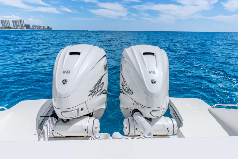 Sea Phase Yacht Photos Pics 2024 Pursuit S 358 Sport boat with twin Yamaha V8 outboard engines on blue ocean.