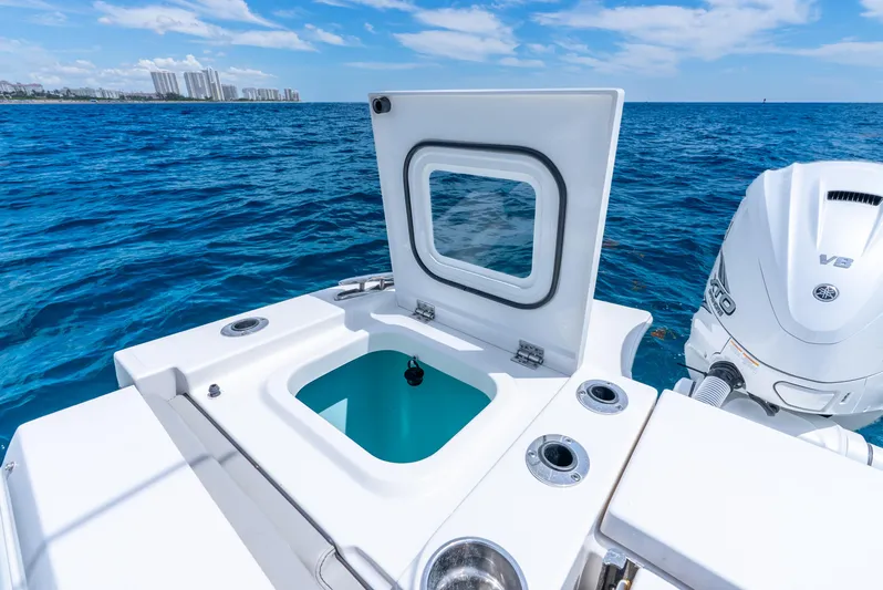 Sea Phase Yacht Photos Pics 2024 Pursuit S 358 Sport boat with open hatch and V8 engine on blue ocean.