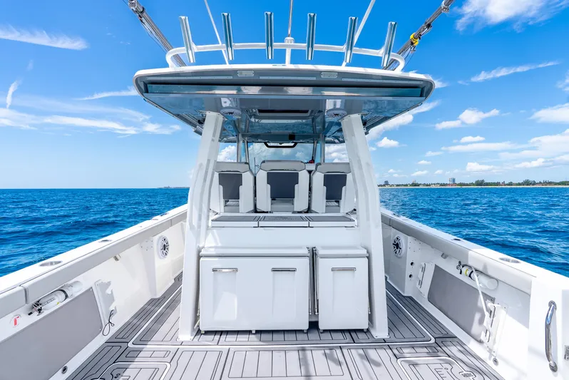 Sea Phase Yacht Photos Pics 2024 Pursuit S 358 Sport boat on open sea under clear blue sky.