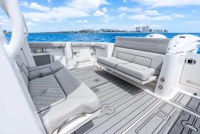 Sea Phase Yacht Photos Pics 2024 Pursuit S 358 Sport boat interior with luxurious seating and ocean view.