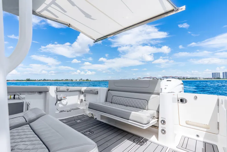 Sea Phase Yacht Photos Pics 2024 Pursuit S 358 Sport boat interior with luxurious seating and ocean view.