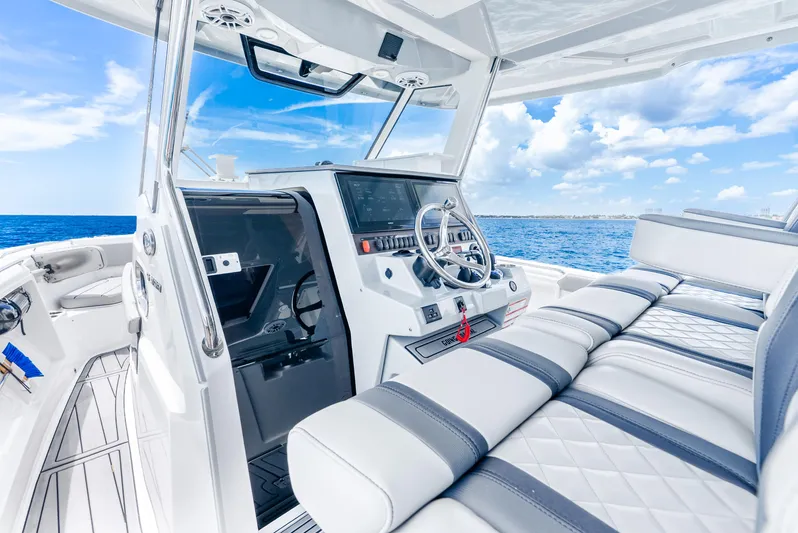 Sea Phase Yacht Photos Pics 2024 Pursuit S 358 Sport boat interior with sleek design and ocean view.
