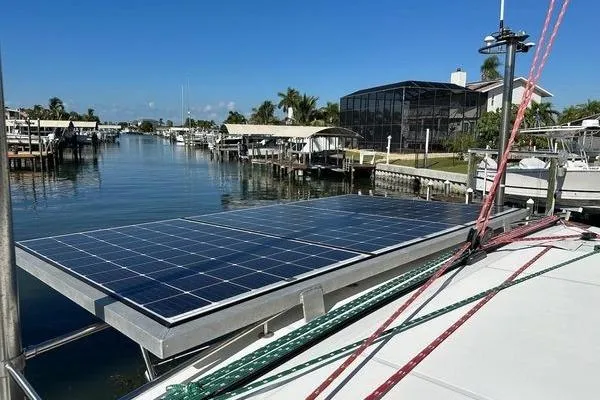 Brizo Yacht Photos Pics Lagoon 440 catamaran (2006) with solar panels docked in a scenic marina.