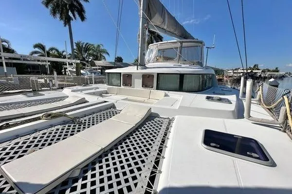 Brizo Yacht Photos Pics 2006 Lagoon 440 catamaran with spacious deck, docked in a sunny marina setting.