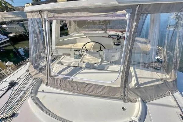 Brizo Yacht Photos Pics 2006 Lagoon 440 catamaran cockpit with clear enclosure and steering wheel.