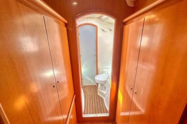 Brizo Yacht Photos Pics Interior of 2006 Lagoon 440 yacht featuring wooden cabinetry and a compact bathroom.