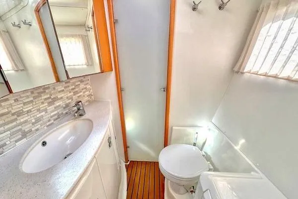 Brizo Yacht Photos Pics Bathroom interior of 2006 Lagoon 440 catamaran with sink, toilet, and shower.