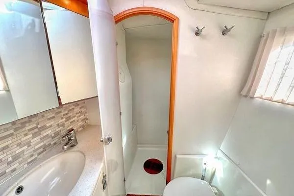 Brizo Yacht Photos Pics Bathroom interior of 2006 Lagoon 440 catamaran with shower, sink, and toilet.