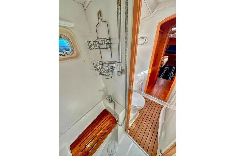 Brizo Yacht Photos Pics Interior of 2006 Lagoon 440 yacht bathroom with shower and wooden flooring.