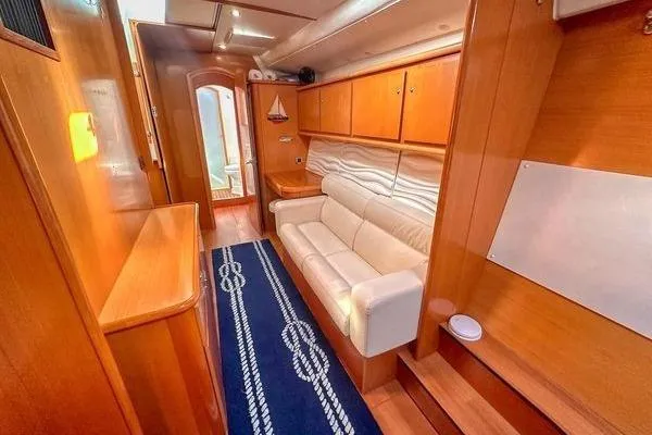 Brizo Yacht Photos Pics Interior of 2006 Lagoon 440 yacht with wooden cabinetry and white sofa.