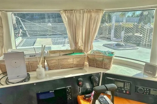 Brizo Yacht Photos Pics Interior view of 2006 Lagoon 440 catamaran cockpit with navigation equipment and wicker baskets.