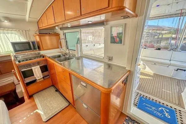 Brizo Yacht Photos Pics Interior of 2006 Lagoon 440 yacht kitchen with modern appliances and wooden cabinetry.