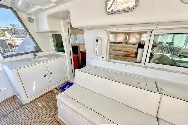 Brizo Yacht Photos Pics Interior of 2006 Lagoon 440 catamaran with white seating and cabinetry.