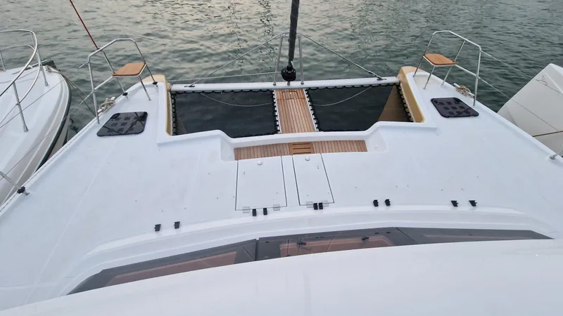  Yacht Photos Pics 2026 Aventura 45 catamaran deck with wooden accents, docked on calm water.