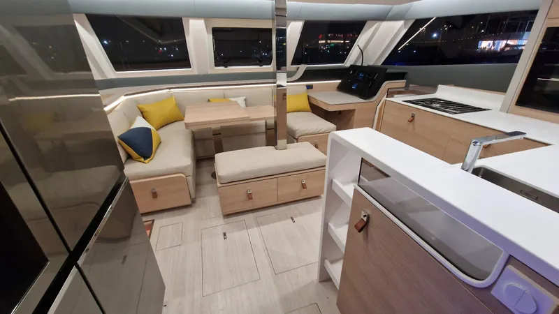  Yacht Photos Pics Modern interior of 2026 Aventura 45 yacht with sleek kitchen and cozy seating area.