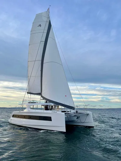  Yacht Photos Pics Aventura 45 catamaran sailing on open water under a clear sky, 2026 model.