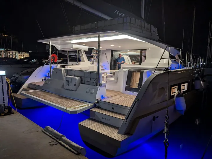  Yacht Photos Pics Aventura 45 yacht, 2026 model, illuminated at night with blue underwater lights.