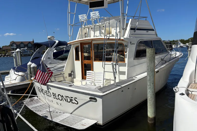  Yacht Photos Pics 1985 Egg Harbor 37 Tournament yacht docked, featuring American flag and "Beached Blondes" name.