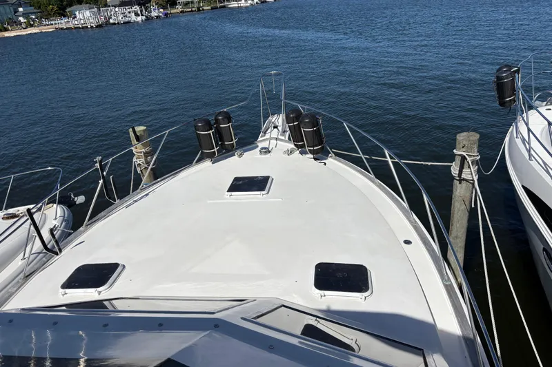  Yacht Photos Pics 1985 Egg Harbor 37 Tournament boat docked at marina, viewed from bow.