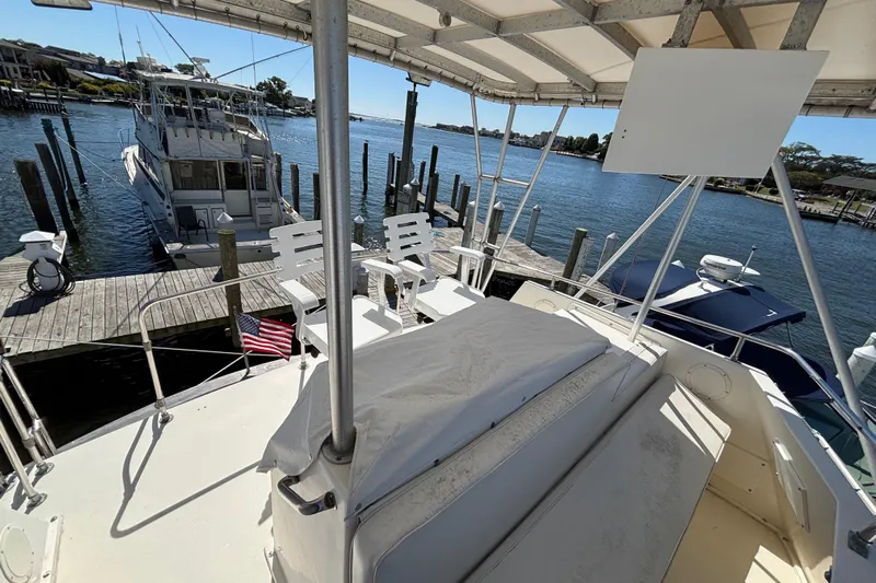  Yacht Photos Pics 1985 Egg Harbor 37 Tournament yacht docked at marina, featuring spacious deck and seating.