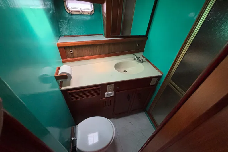  Yacht Photos Pics Bathroom interior of 1985 Egg Harbor 37 Tournament yacht with teal walls and wood accents.