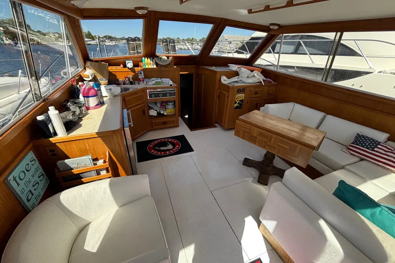  Yacht Photos Pics Interior of 1985 Egg Harbor 37 Tournament yacht with cozy seating and wooden accents.