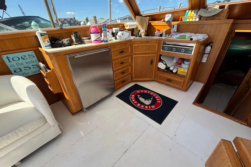  Yacht Photos Pics Interior of 1985 Egg Harbor 37 Tournament boat with kitchenette and Nantucket Boat Basin mat.