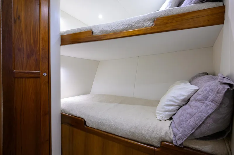  Yacht Photos Pics Bunk beds in 2006 Blackwell Custom Carolina yacht cabin, featuring wooden finish and cozy bedding.