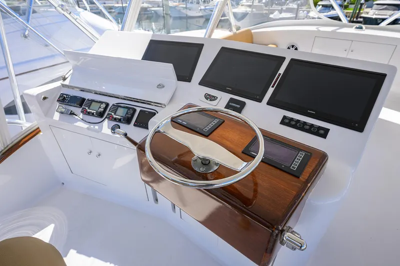  Yacht Photos Pics Helm of 2006 Blackwell Custom Carolina boat with modern navigation equipment and wooden steering wheel.