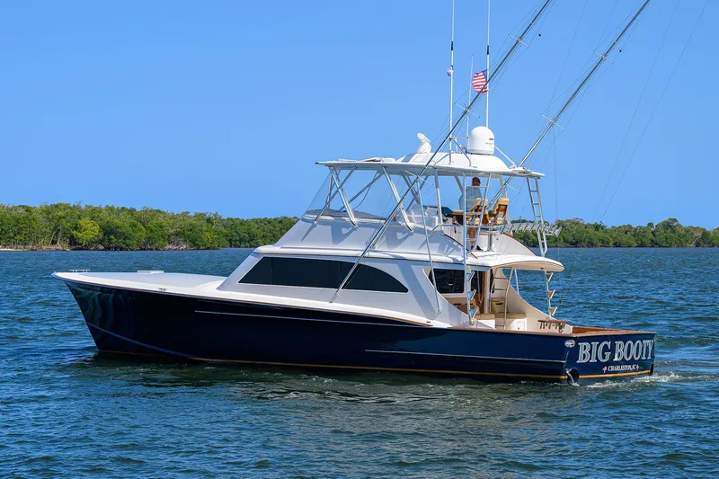  Yacht Photos Pics 2006 Blackwell Custom Carolina yacht on water, clear sky, lush green shoreline.