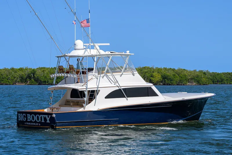  Yacht Photos Pics 2006 Blackwell Custom Carolina yacht on water, blue hull, white superstructure, American flag flying.