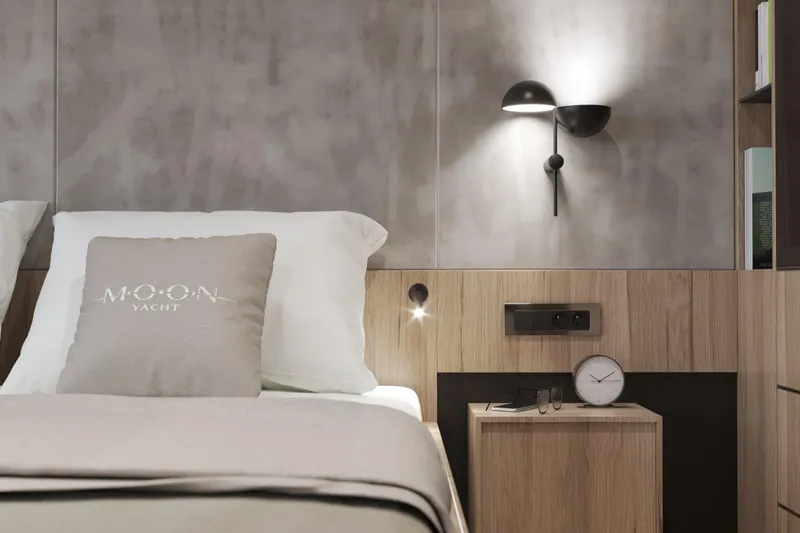  Yacht Photos Pics Modern yacht bedroom with sleek design, featuring Moon Yacht pillow and stylish wall lighting.