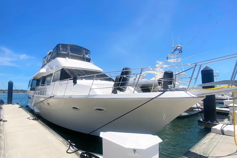 Sea Sharp Yacht Photos Pics 1990 Viking 63 Motor Yacht docked under clear blue sky.