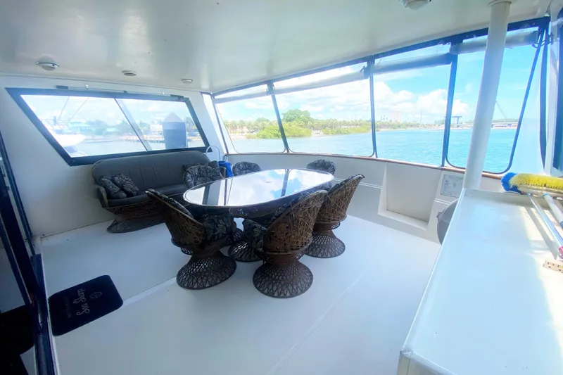 Sea Sharp Yacht Photos Pics Spacious interior of 1990 Viking 63 Motor Yacht with elegant dining area and scenic views.