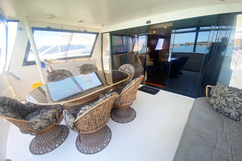 Sea Sharp Yacht Photos Pics Luxurious 1990 Viking 63 Motor Yacht interior with elegant dining area and scenic views.