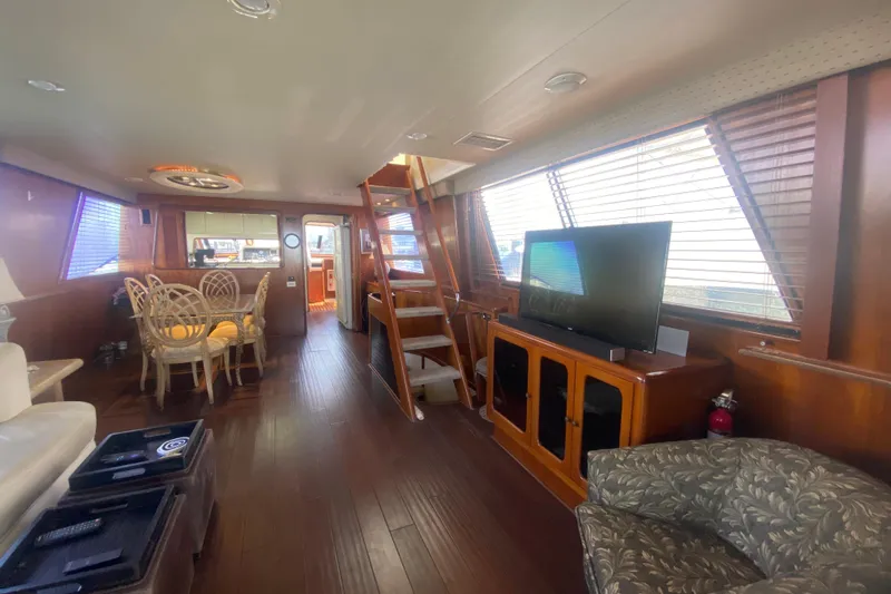 Sea Sharp Yacht Photos Pics Luxurious interior of 1990 Viking 63 Motor Yacht with dining area and entertainment setup.