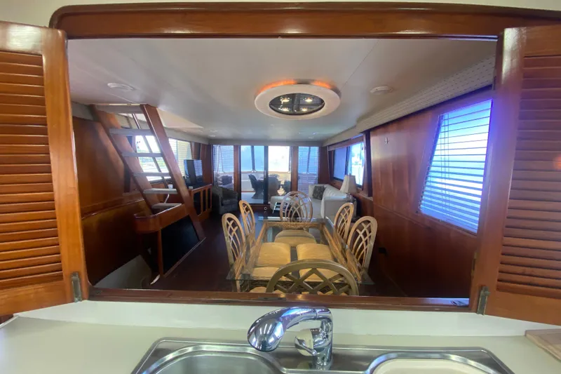 Sea Sharp Yacht Photos Pics Interior of 1990 Viking 63 Motor Yacht with dining area and wooden accents.