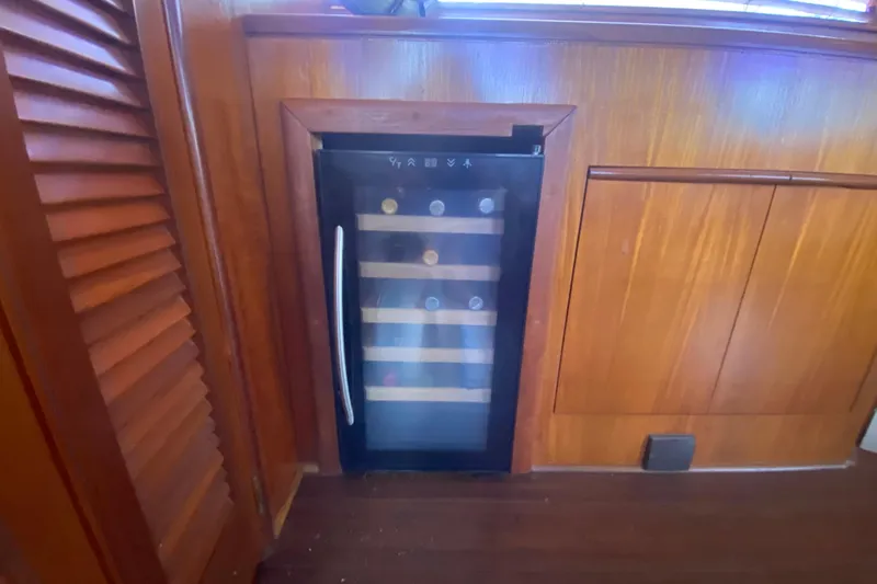 Sea Sharp Yacht Photos Pics Wine cooler in wooden interior of 1990 Viking 63 Motor Yacht.
